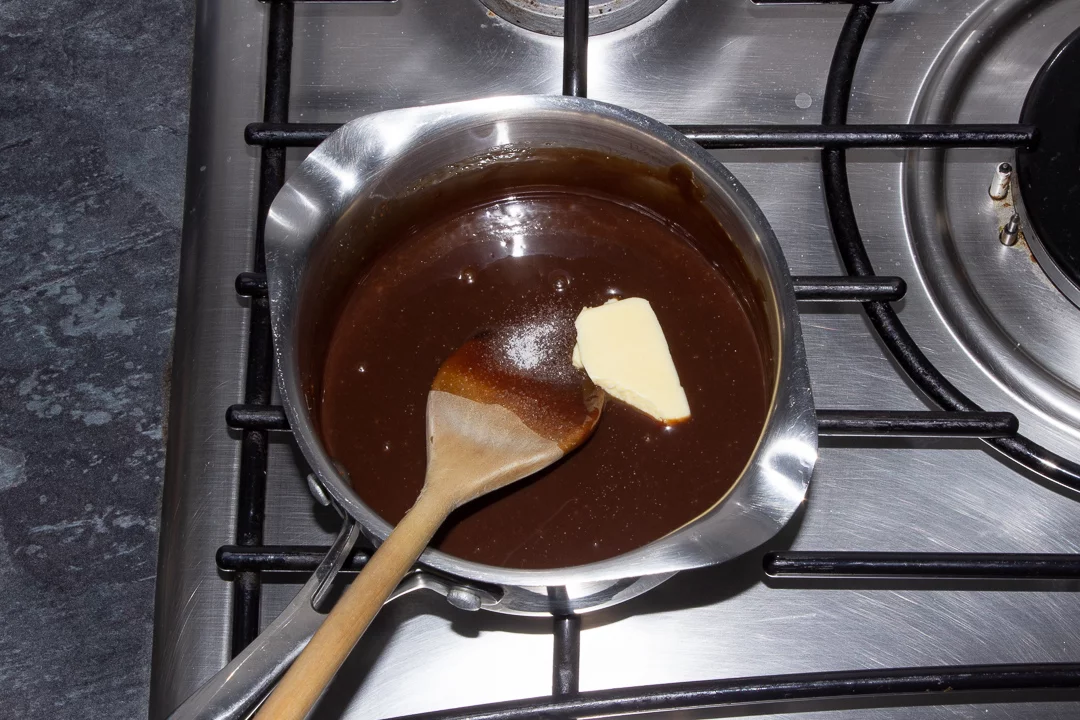 Baileys milk chocolate sauce in a saucepan over a low heat with butter and salt being stirred through
