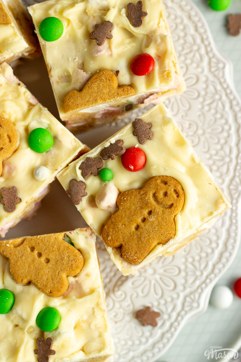 Squares of Christmas rocky road on a lace white plate with Christmas sprinkles scattered around