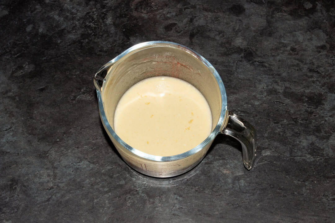 .Yorkshire pudding batter in a glass jug.