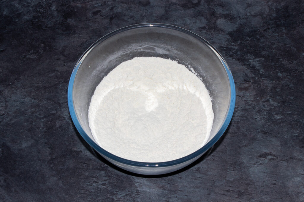 flour and salt mixed together in a large glass mixing bowl