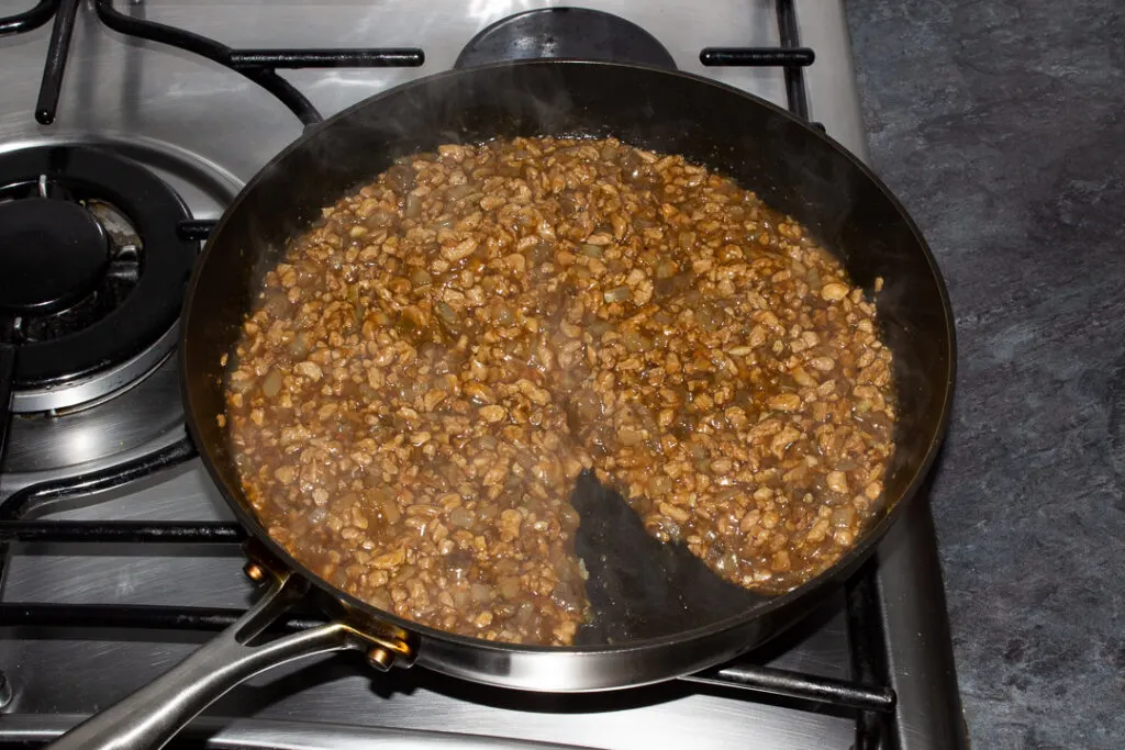 Cooked vegetarian mince and onion pie filling in a frying pan