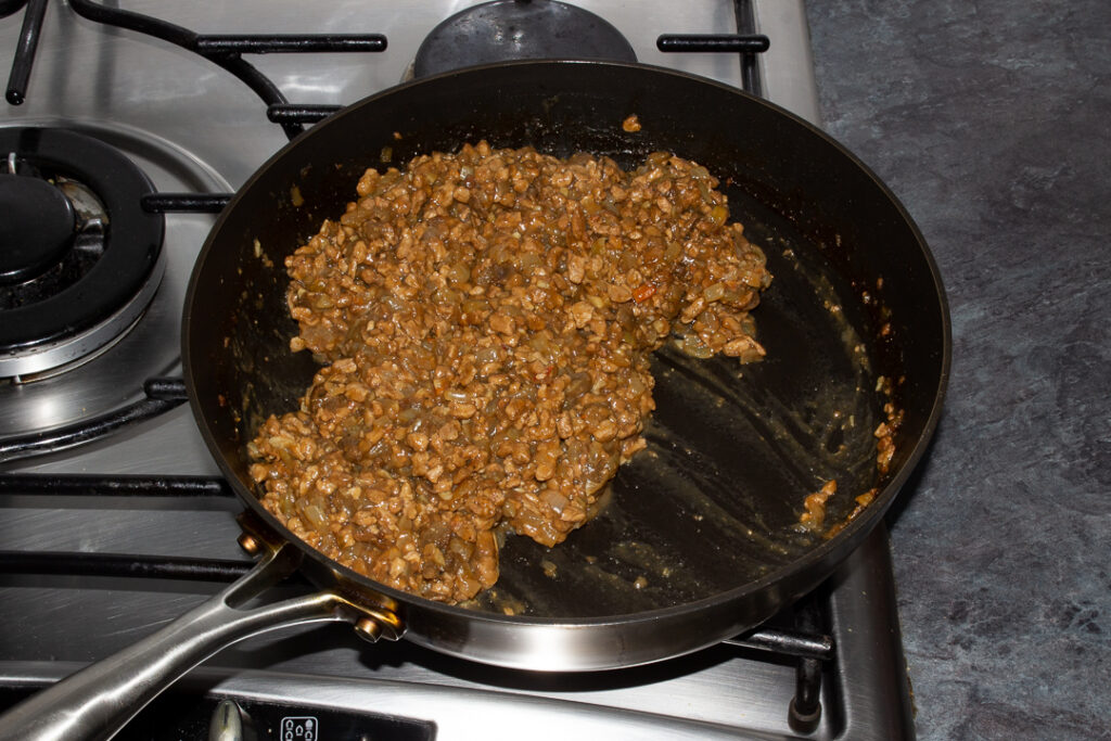 Cooked and cooled vegetarian mince and onion pie filling in a frying pan
