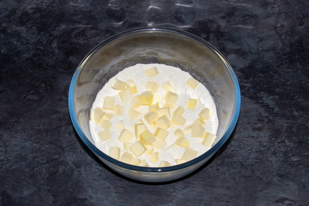 flour, salt and cubed butter mixed together in a large glass mixing bowl