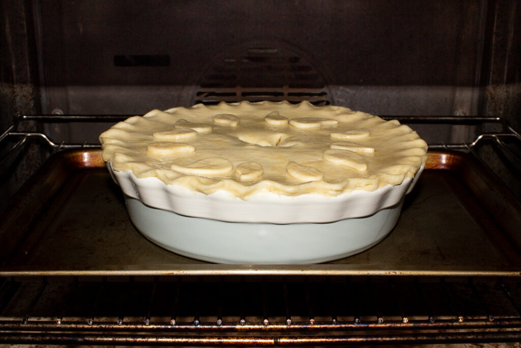 Vegetarian mince and onion pie on a baking tray in the oven