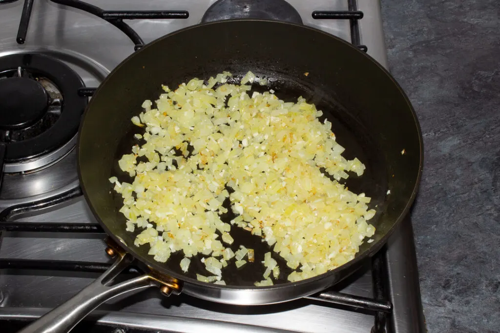 Cooked onion and garlic in a frying pan
