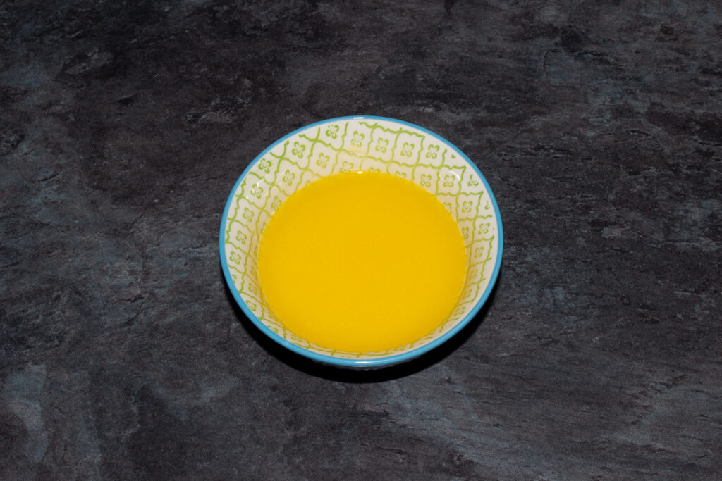Melted butter in a small blue patterned bowl