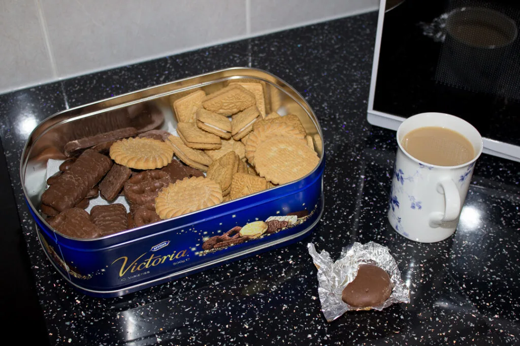 A tin of biscuits and a cup of tea on Gran's kitchen worktop