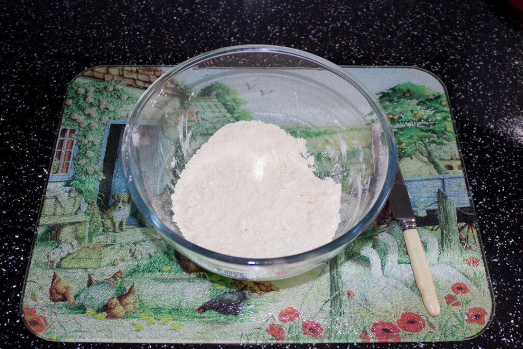 Flour, Trex and salt in a mixing bowl on a kitchen worktop