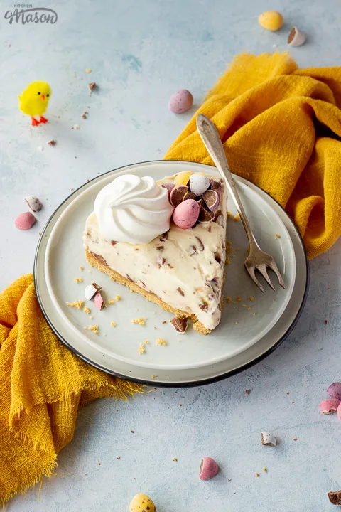 A slice of no bake Mini Egg cheesecake on a plate with a fork
