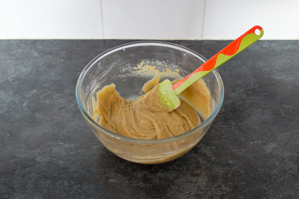 Blondie batter in a glass bowl with a spatula