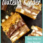 Close up of 3 white chocolate kinder nutella cookie bars on their sides set on an iron plate with white chocolate chips, kinder bars and cookie crumbs scattered around it.