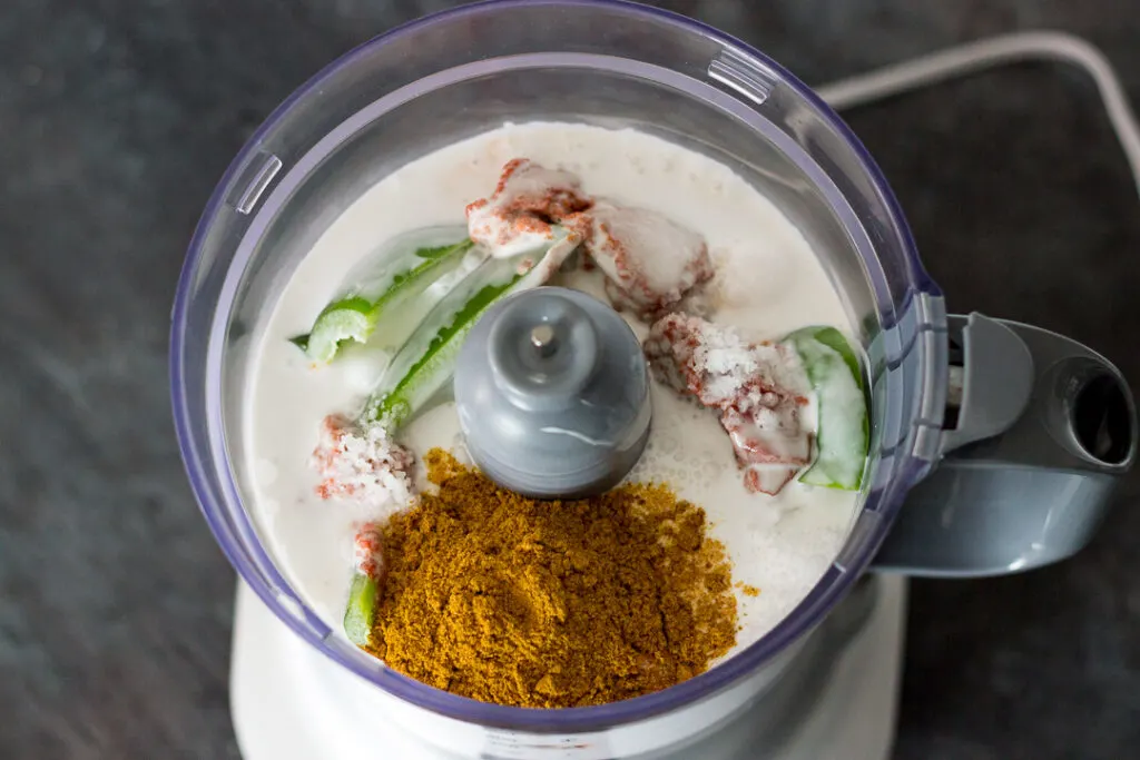 Curry sauce ingredients in a food processor.