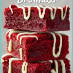 Red velvet brownies drizzled with white chocolate in a stack of 3 against a light neutral backdrop.