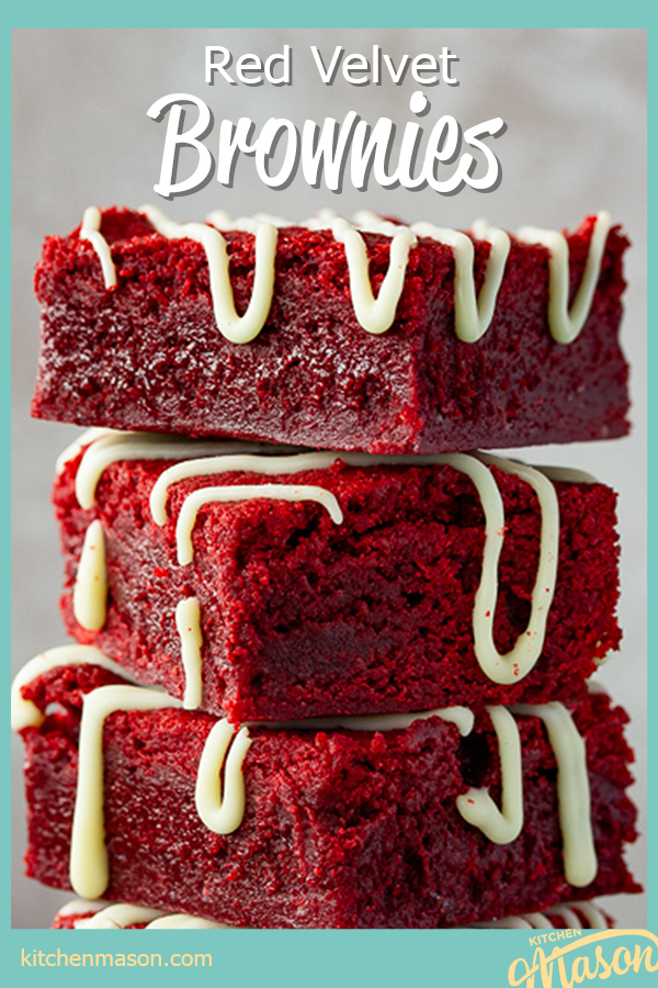 Red velvet brownies drizzled with white chocolate in a stack of 3 against a light neutral backdrop.