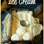Font view of vanilla ice cream in a lined loaf tin with 3 scoops at the end and a spoon on top. Set over a crumpled light brown napkin over a deep blue mottled backdrop. There are 2 waffle cones in the background.