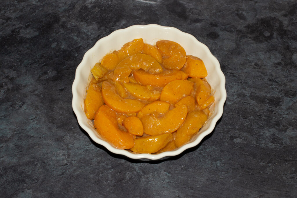 Peach mixture in a fluted ceramic serving dish.