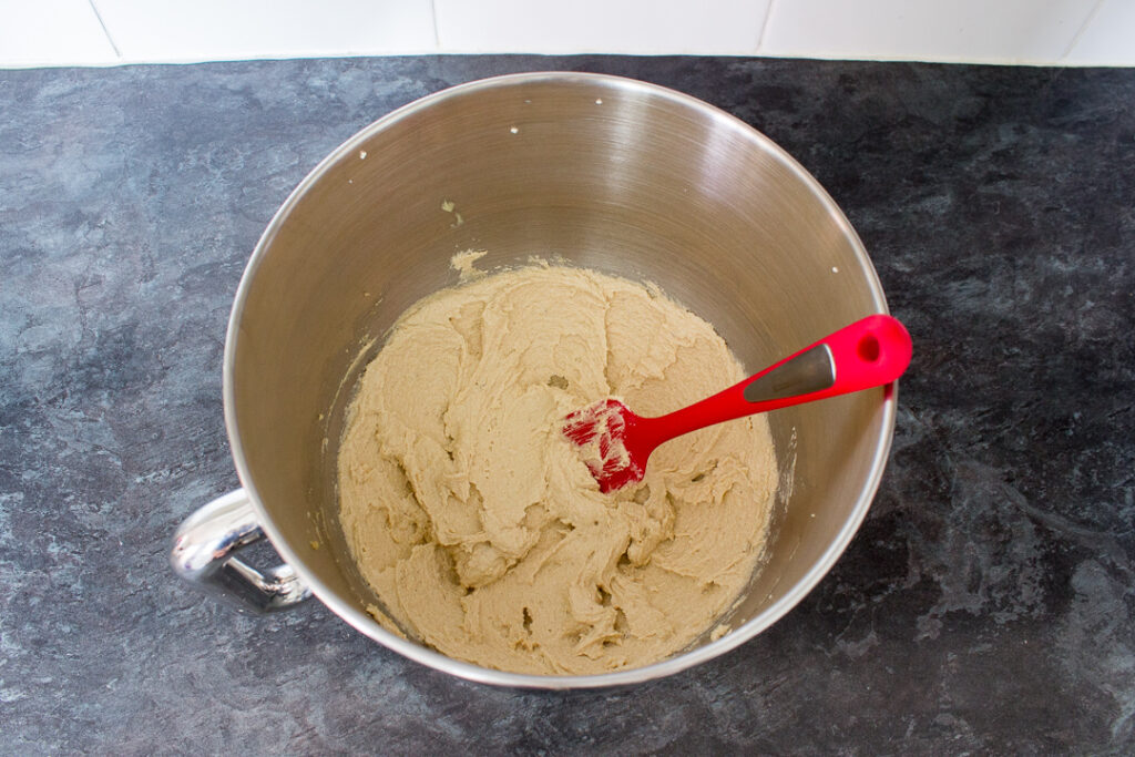 Butter and sugar creamed together in the bowl of an electric stand mixer on a kitchen worktop.