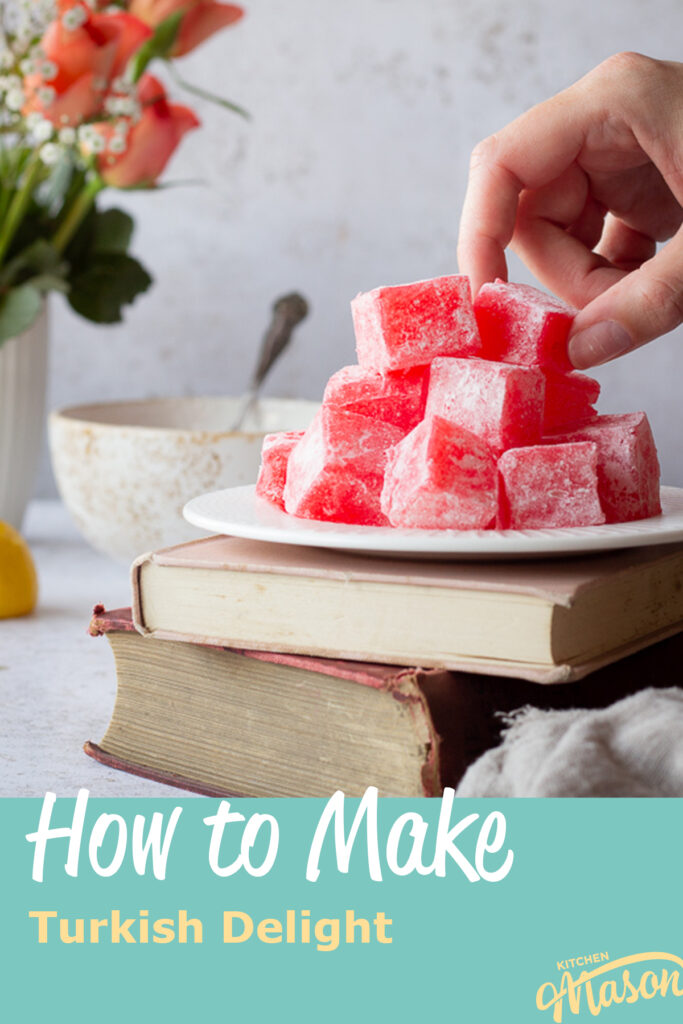 A white plate filled with homemade Turkish delight set on the top of two old books with a light brown linen napkin at the side.