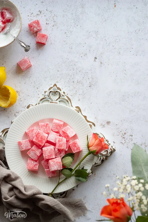 A work surface where someone has coated Turkish delight in icing sugar