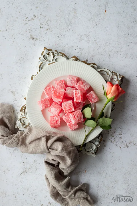 Homemade Turkish delight on an embossed white board with a linen napkin
