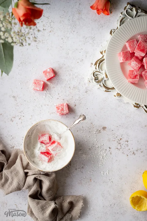 Cubes of Turkish delight in a bowl of icing sugar