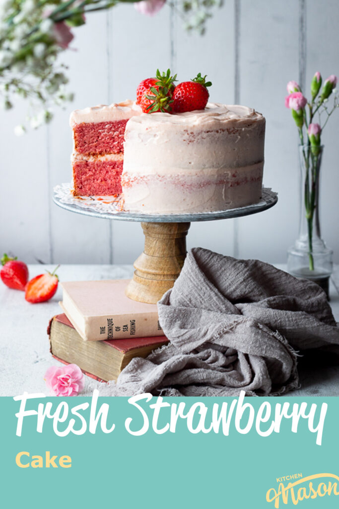 A strawberry cake with a slice cut out on a cake stand. A text overlay says "fresh strawberry cake".