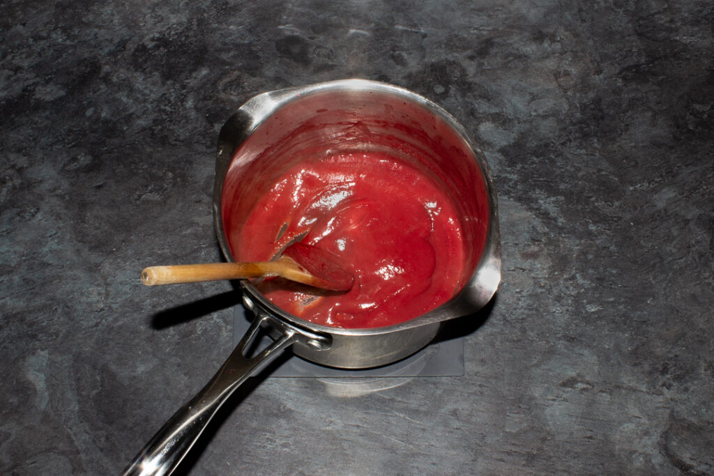 Reduced strawberry puree in a saucepan