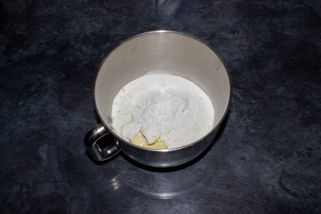 Lemon cake ingredients in a stand mixer bowl.