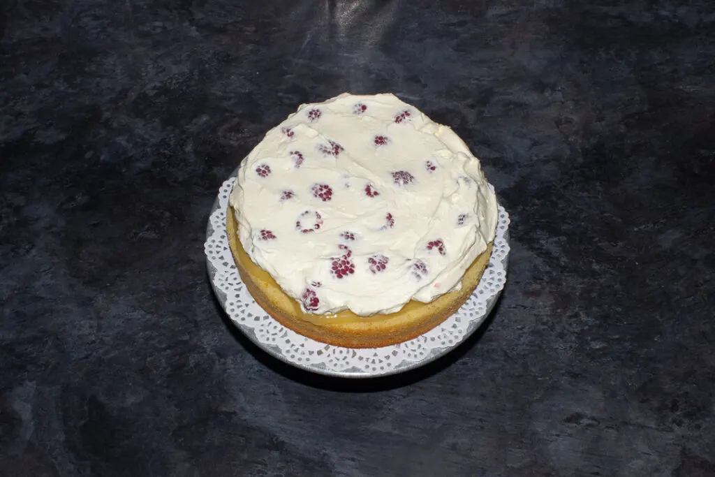 Sweetened raspberry cream spread on cake.