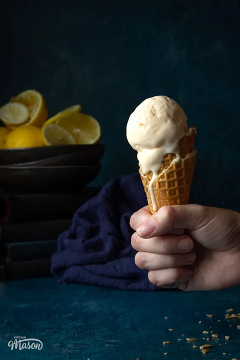 Lemon ice cream melting down a waffle cone