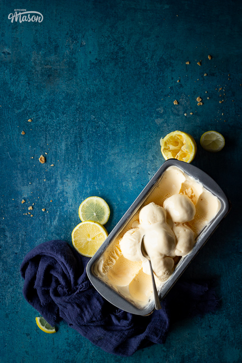 Homemade lemon ice cream and a spoon in a loaf tin