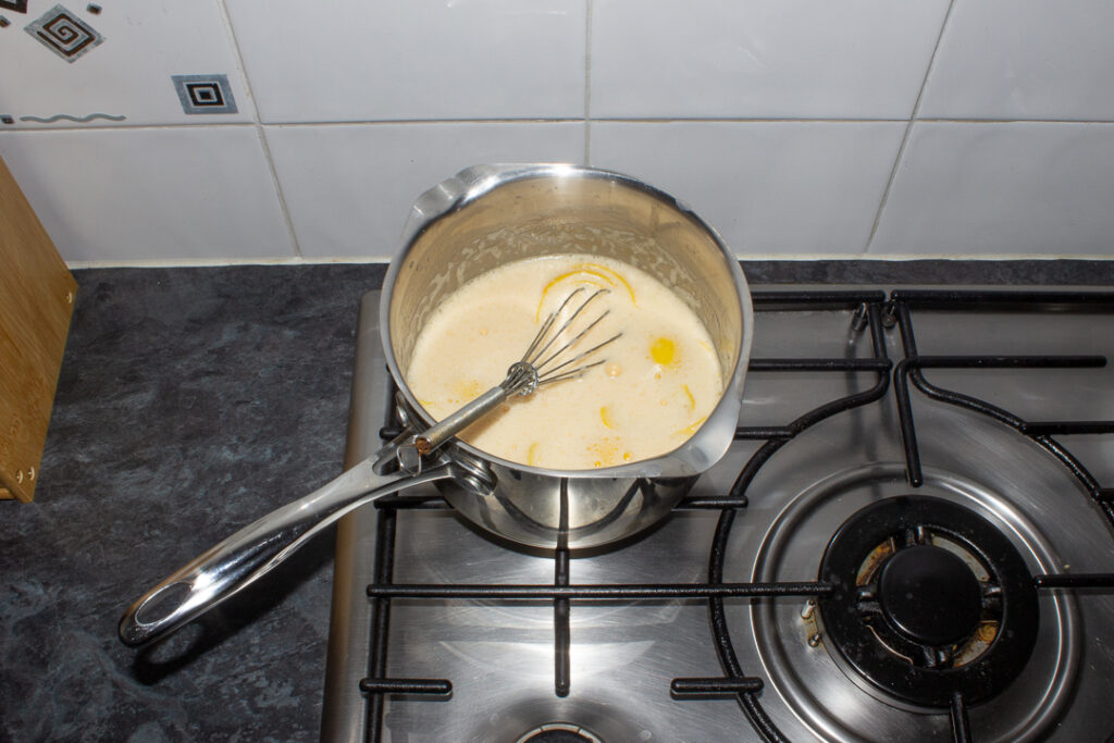 Lemon custard heating up in a saucepan