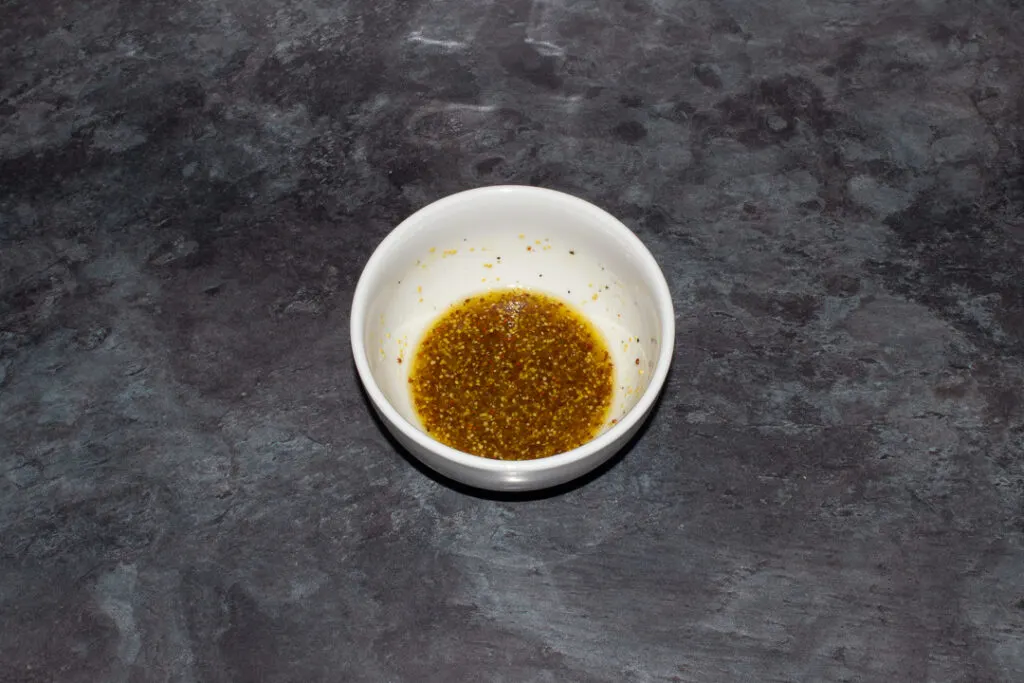 Tomato salad dressing in a small white bowl