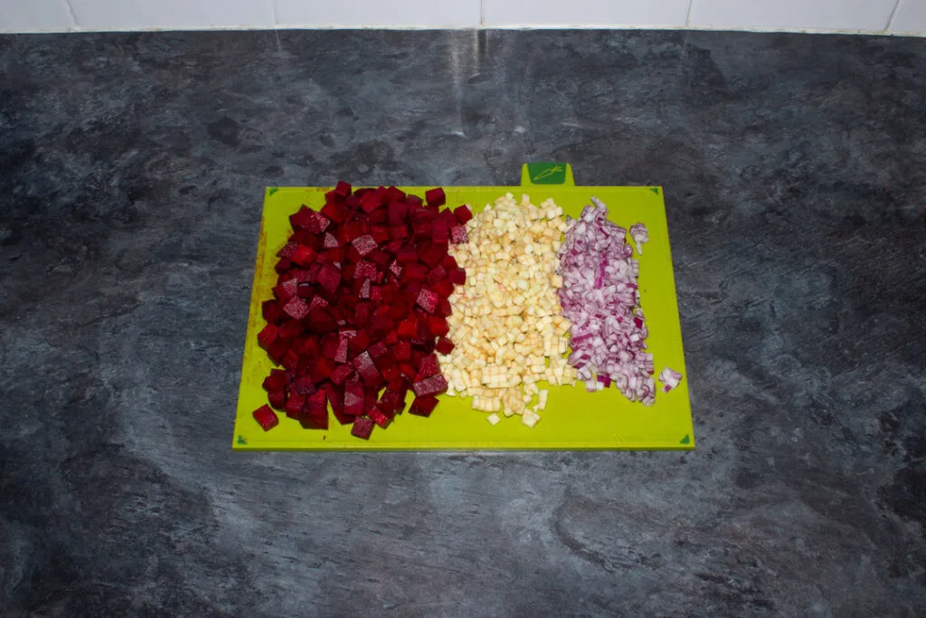 Diced beetroot, apple and onion on a chopping board