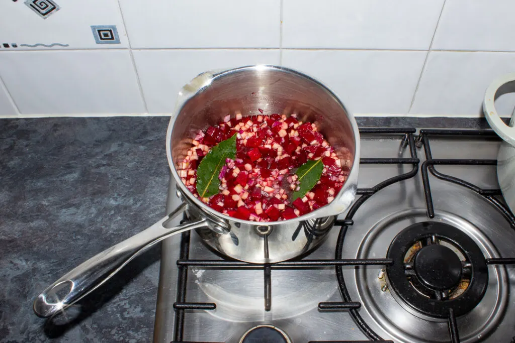 Beetroot chutney ingredients in a saucepan on a stove top