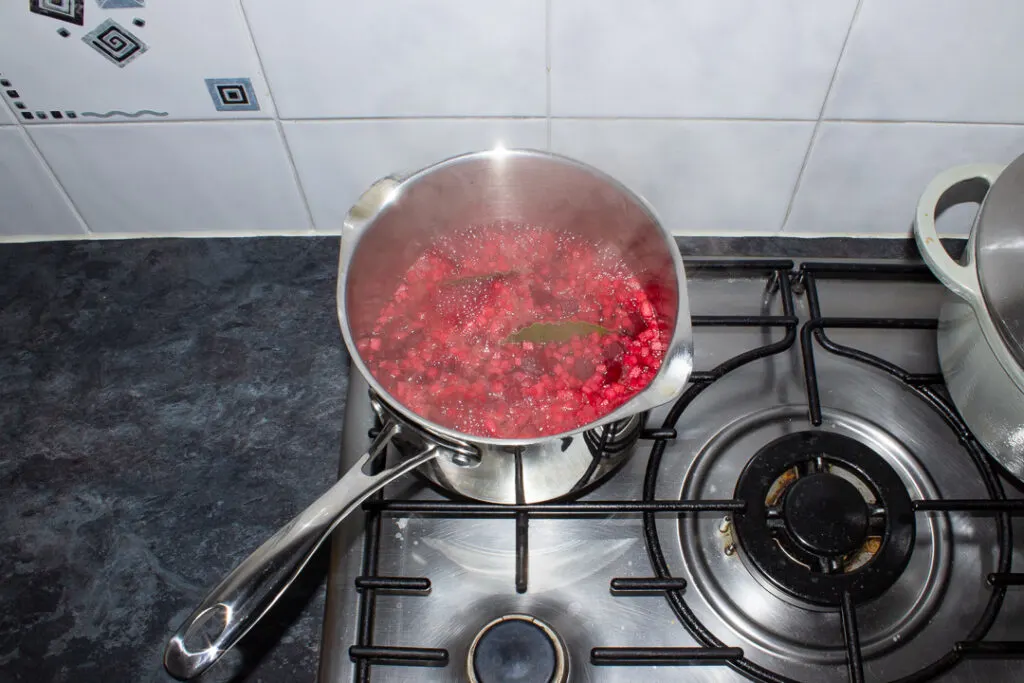 Beetroot apple and onion boiling in a saucepan