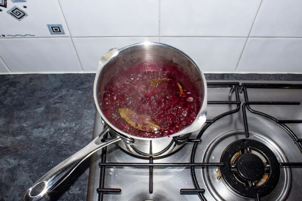 Beetroot chutney reducing in a pan