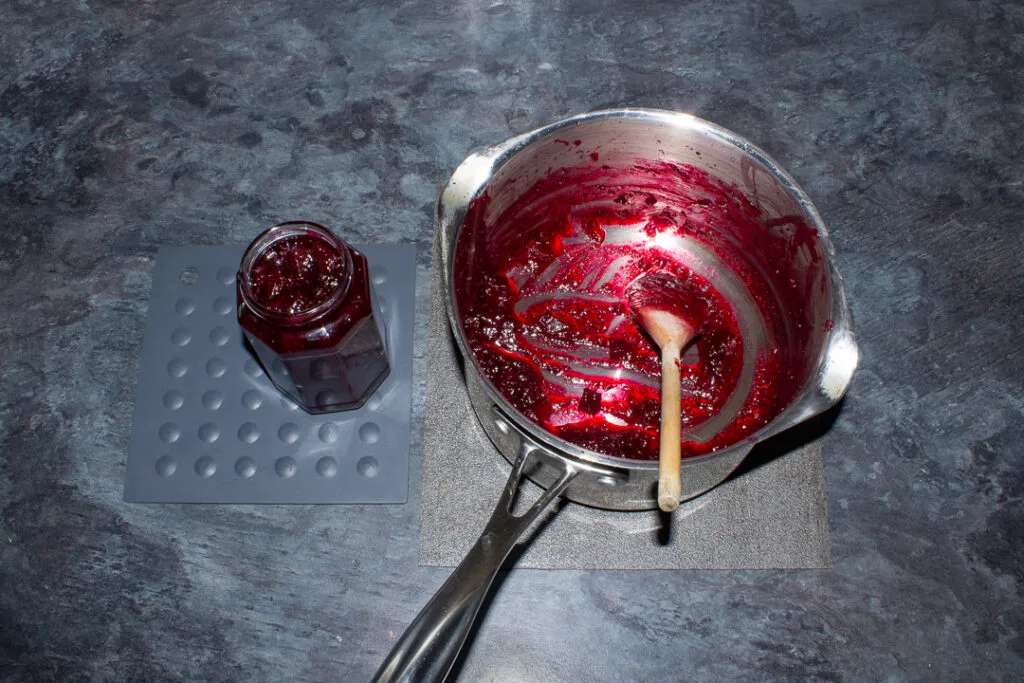 Beetroot chutney being poured into a jar