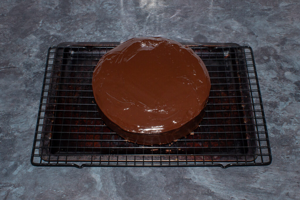 A biscuit cake covered in chocolate ganache