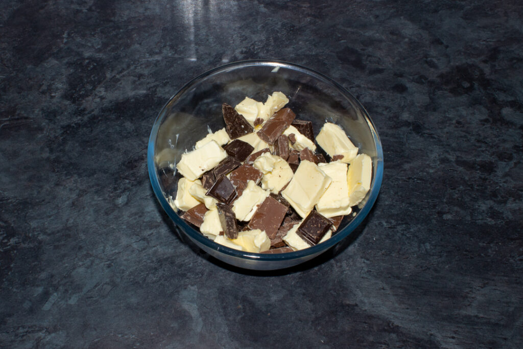 Cubed butter and broken chocolate in a bowl