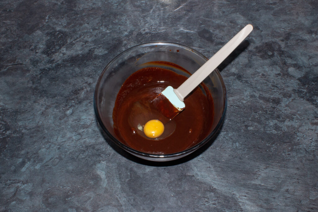 Melted chocolate, butter and egg in a mixing bowl