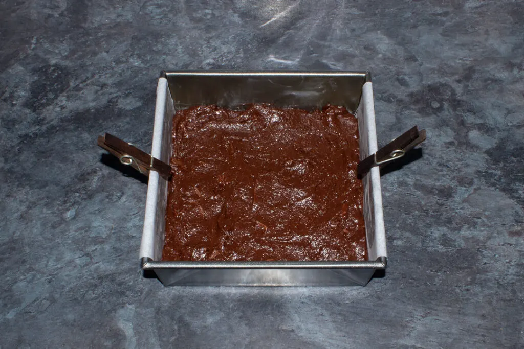 Chocolate orange brownie batter in a lined tin