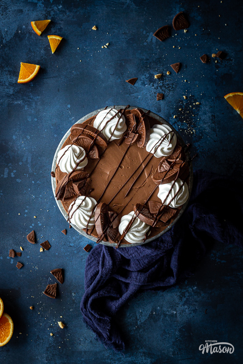 Terry's chocolate orange cheesecake on a cake stand