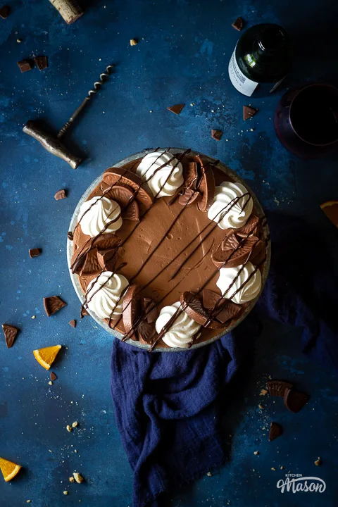 Top down view of an easy chocolate orange cheesecake on a stand