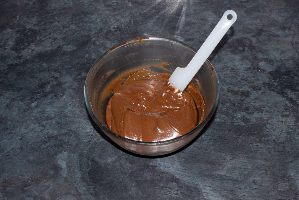 Partial chocolate orange cheesecake filling in a glass bowl