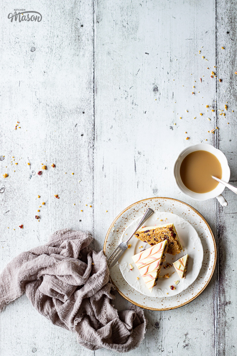 A slice of white chocolate tiffin on a plate with a cup of tea