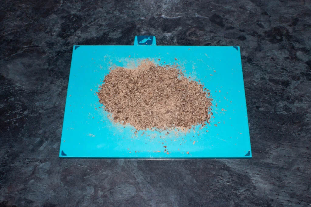 Finely chopped chocolate on a chopping board