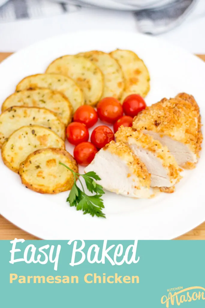 Baked parmesan chicken on a plate with potato thins and tomatoes