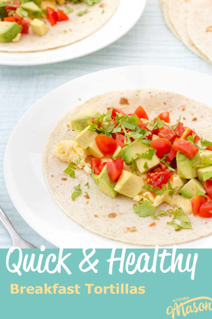 Healthy avocado egg and tomato breakfast tortillas on a white plate