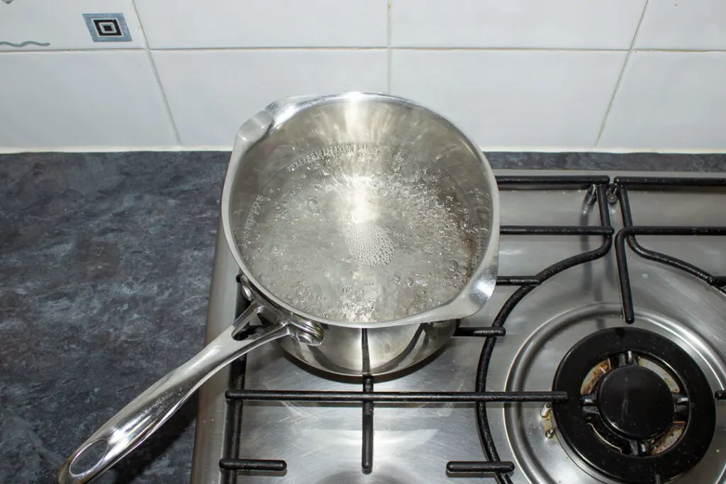 A pan of boiling water on the stove